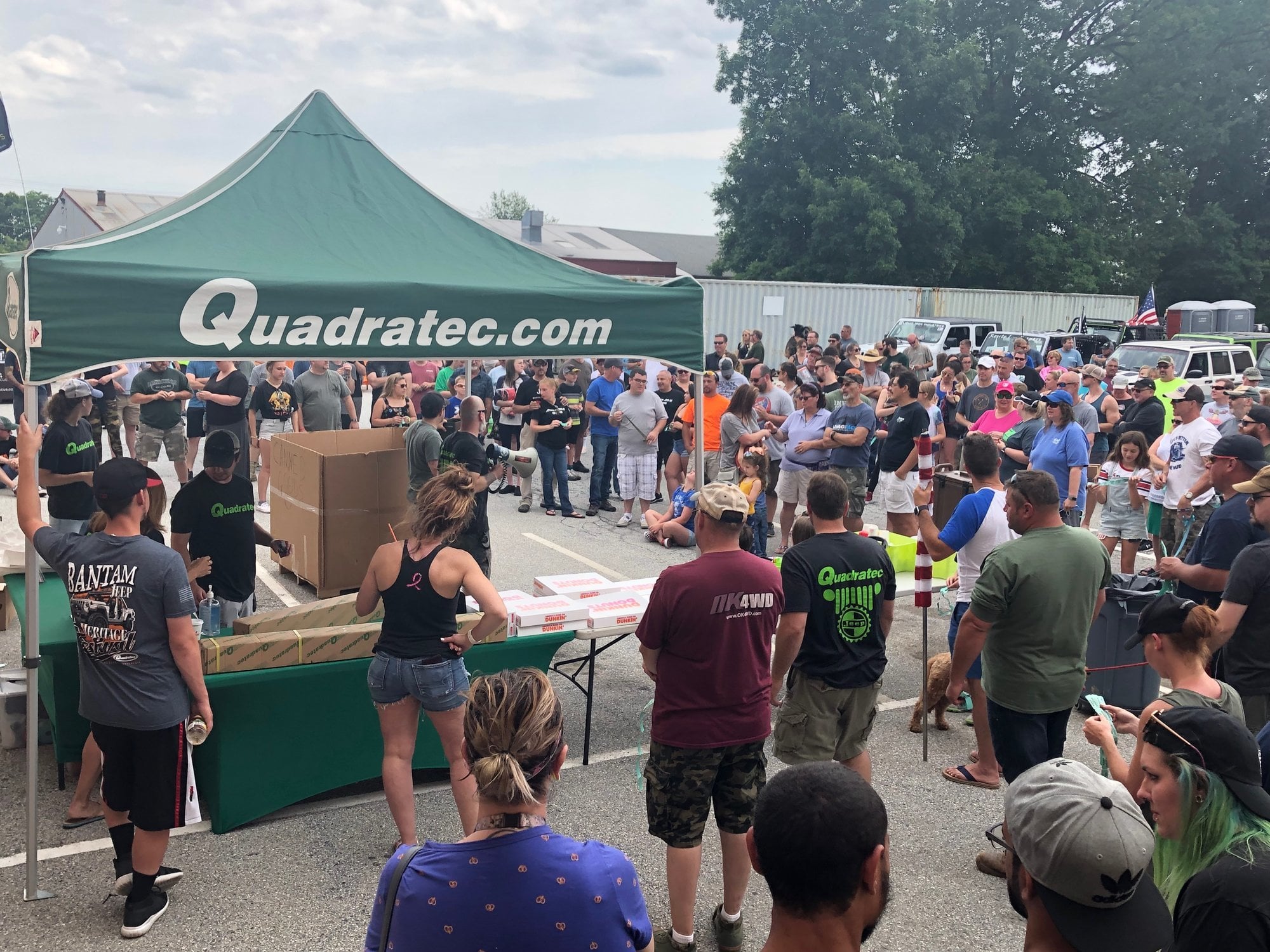 Green Quadratec tent with crowd in background