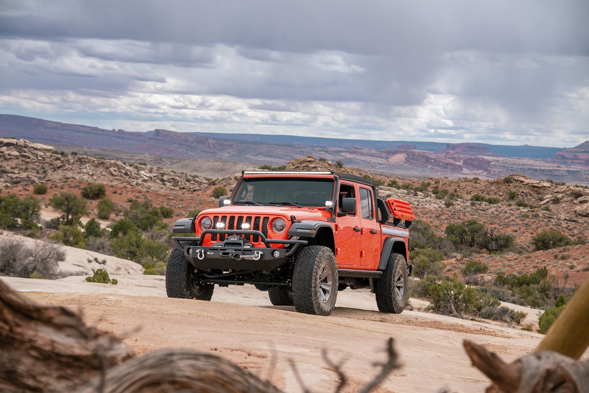 Orange Jeep truck with desert background